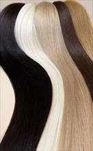Strands of natural hair of different colors for extensions