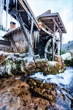 Water mill in snow and ice in winter