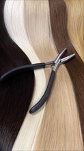 Strands of natural hair in different colors for extensions with tools