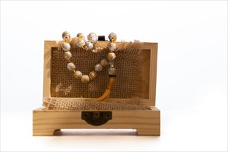 Mala tibetan in wooden box white background and copy space