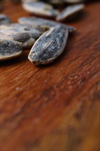 Close-up of roasted sunflower seeds with salt selective focus on a wooden table