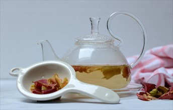 Apple peel tea in teapot and apple peel in tea strainer