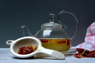 Apple peel tea in teapot and apple peel in tea strainer