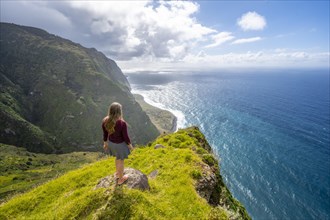 Young woman enjoying view of cliffs and sea