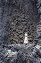 Statue of the Virgin Mary on a rock