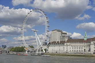 The London Eye Ferris Wheel and County Hall on the banks of the Thames