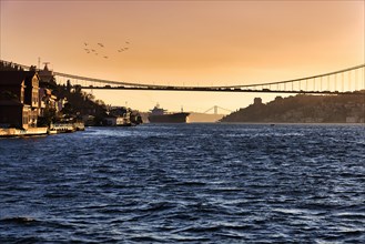 Cargo ship under the Fatih Sultan Mehmet Bridge