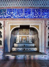 Fountain in a wall with mosaics and Arabic calligraphy