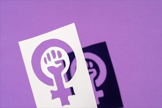 Symbol of the struggle of feminism on a purple background