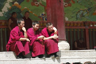 Monks on a staircase in Labrang Tibetan Monastery