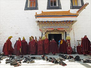 Yellow-capped monks and shoes at the prayer hall