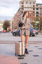 Tourist woman with suitcase on vacation in the city