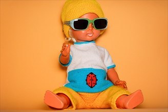 Cool doll with sunglasses and yellow knitted cap