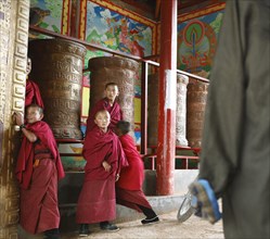 Novices playing at prayer wheels at Tseway Monastery