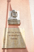 Bust of Sebastian Kneipp at the town hall in the old town of Bad Groenenbach in fine weather