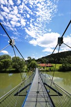 Steel suspension bridge over the Iller in fine weather