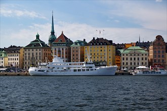 Excursion boats in front of old town houses in Gamla Stan district