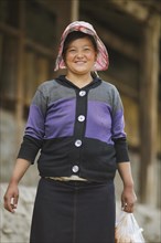 Laughing Tibetan woman with cap