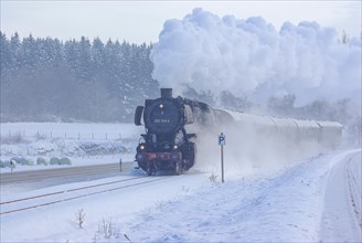 Steam train of the Swabian Alb Railway with steam locomotive 052740-8 on the line between Muensingen and Engstingen