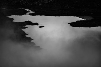 Mountain lake Lej da Vadrett with fog