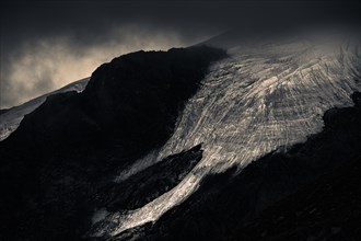 Bernina Group with Rosegg Glacier and dramatic clouds at blue hour