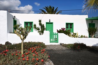 House with green door and green windows on Playa Quemada beach