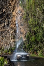 Car driving through Anjos waterfall at Camiho das Fentes