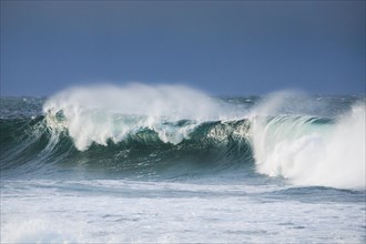 Big wave breaks in the open sea on the Breton coast near Brest