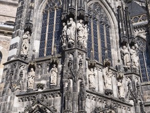 The magnificent church facade of the UNESCO World Heritage Aachen Cathedral with large human figures