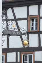 Nose sign of the pharmacy with suns at the church square in Kelkheim