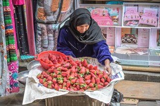 Woman selling fresh strawberries