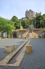 View of Klopp Castle from Mayor Franz Neff Square with fountain and water feature with water channel
