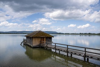 Boathouse at Lake Kochel with cloudy sky