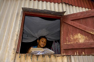 Girl studying in a little hut