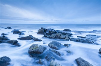 Stormy sea at dawn during the blue hour