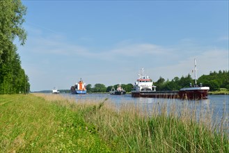 Freighters and container ships sailing in the Kiel Canal