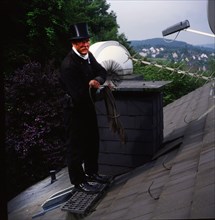 Chimney sweep in professional training and posing in a photo studio