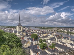 Panorama of the town of Saumur with the dominating bell tower of the Eglise Saint-Pierre-du-Marais and the Loire with the old bridge Pont Cessart