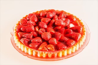 Fresh strawberry cake on a glass cake plate