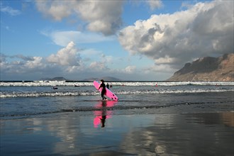 Surfer on the beach of Caleta de Famara