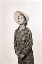 Portrait of a young girl wearing a sun hat