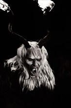 Klausen mask with burning horns in the dark