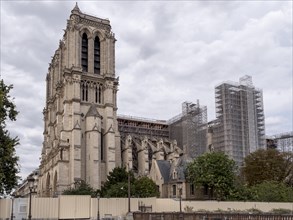 Side view of Notre-Dame de Paris Cathedral with large scaffolding for fire repairs
