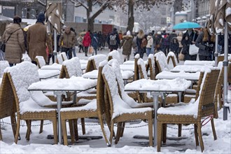 Snow-covered tables and chairs