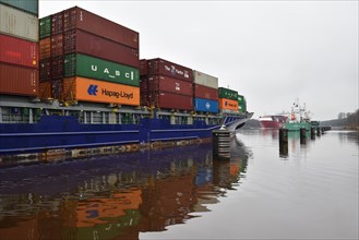 Container ship Munksund waits in a passing place for oncoming traffic in the Kiel Canal