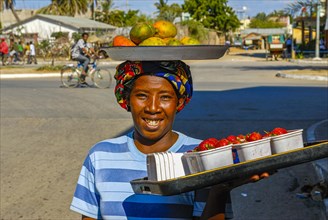 Freindly woman selling fruits on the street