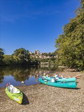 Canoes on the banks of the Dordogne and the Chateau de Beynac