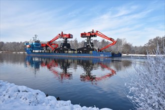 Heavy goods transporter travelling through the Kiel Canal in winter