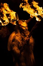 Klausen mask with burning horns in the dark