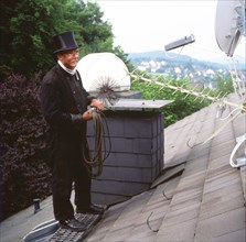 Chimney sweep in professional training and posing in a photo studio